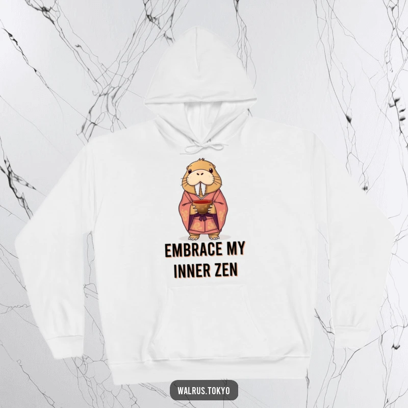 Funny hoodie featuring a dignified walrus, elegantly dressed in a formal kimono, holding a tea bowl, blending comfort with comical sophistication.